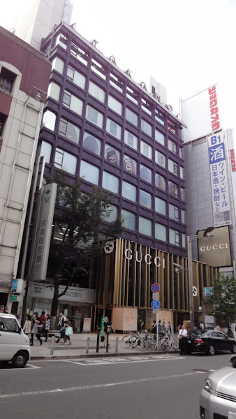 a purple building houses a gucci store